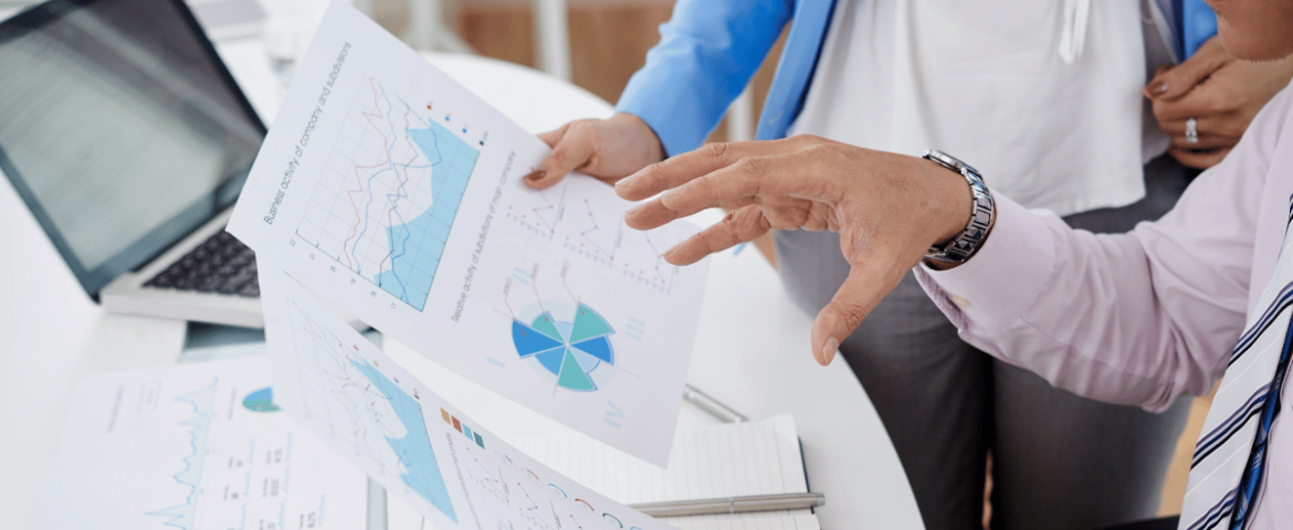 Healthcare professionals reviewing claim denial rate benchmark charts and revenue cycle data reports